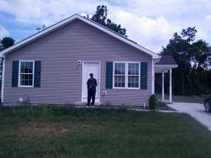 Robert Scott in front of his new home.