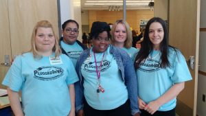 Stacey (far right) and her GED cohort wearing their new PluggedIn VA shirts.