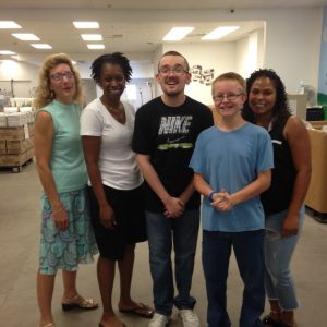 Goodwill's case manager Jeanette (far left) and job coach Karen (left) with students, Aaron and Kyler at their Community Depot job site.