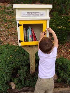 little boy taking a book to read